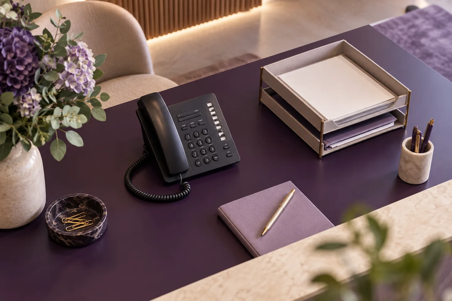 Reception desk with elegant multi-button desk phone and organised trays